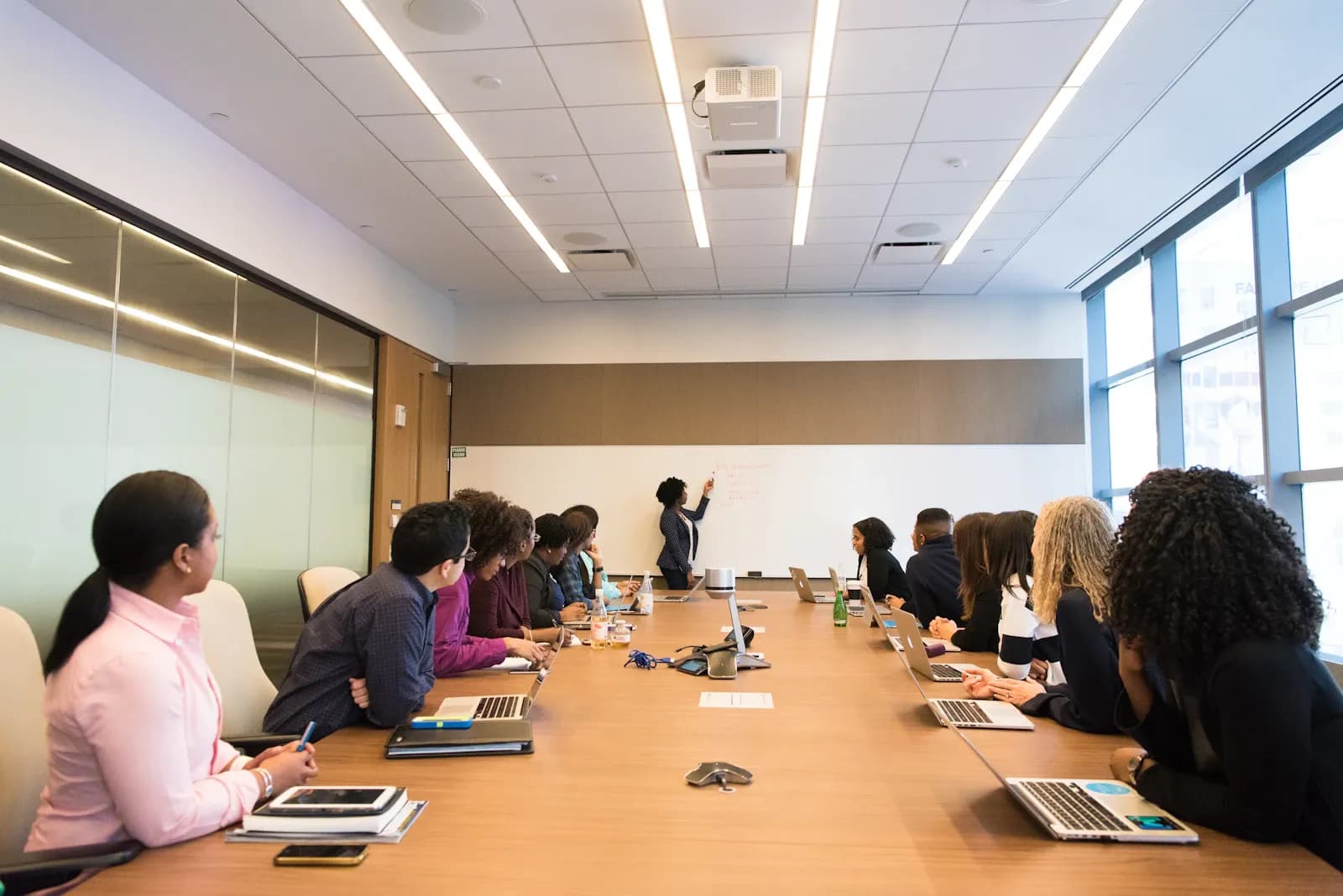 A presenter briefing an executive team on risk posture in a boardroom